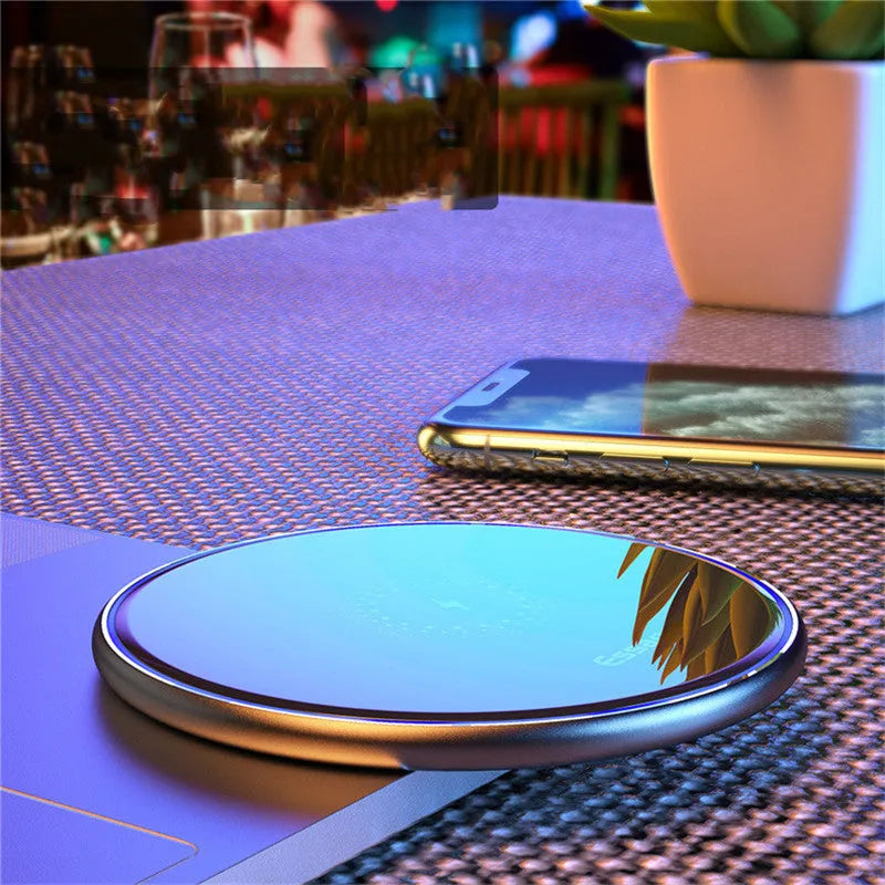 Black aluminium wireless charging pad with LED indicator light on smooth surface