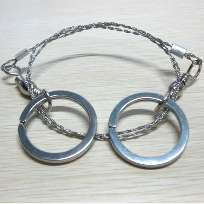 Outdoor survival wire saw with stainless steel blade, pull rings, and hoop showing 55cm cutting length