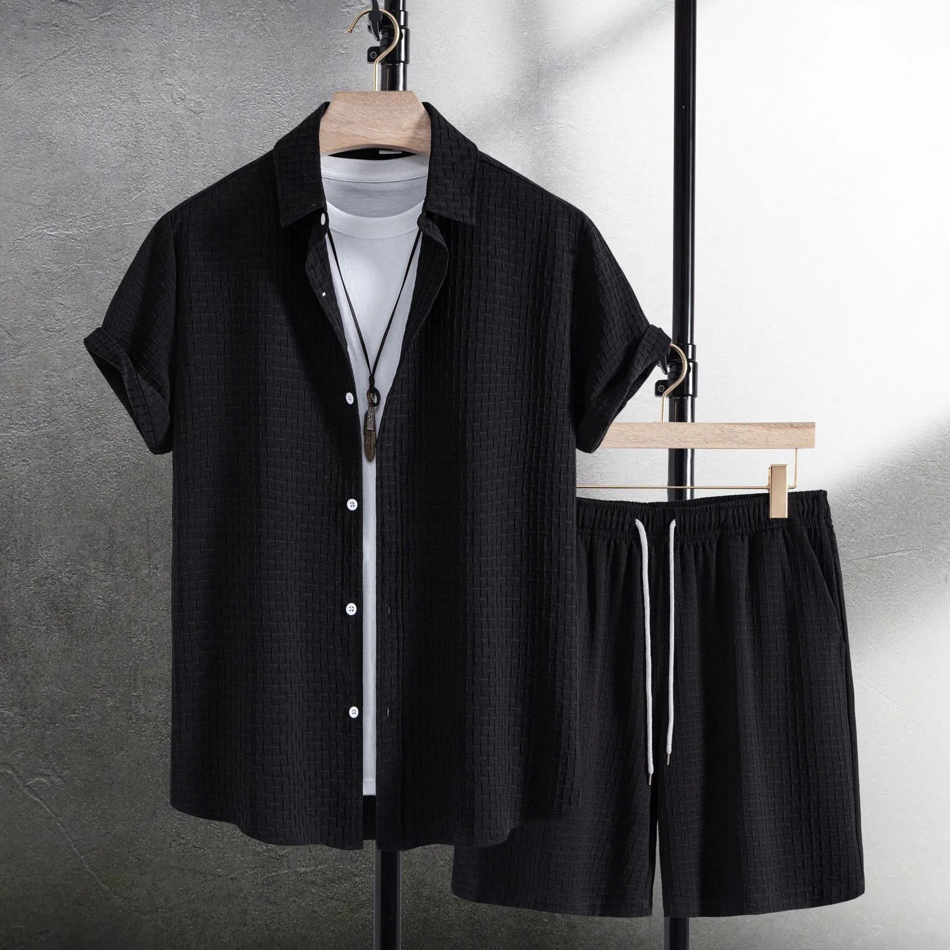 Men's loose-fit cotton blend shirt and shorts co-ord set in solid black colour.