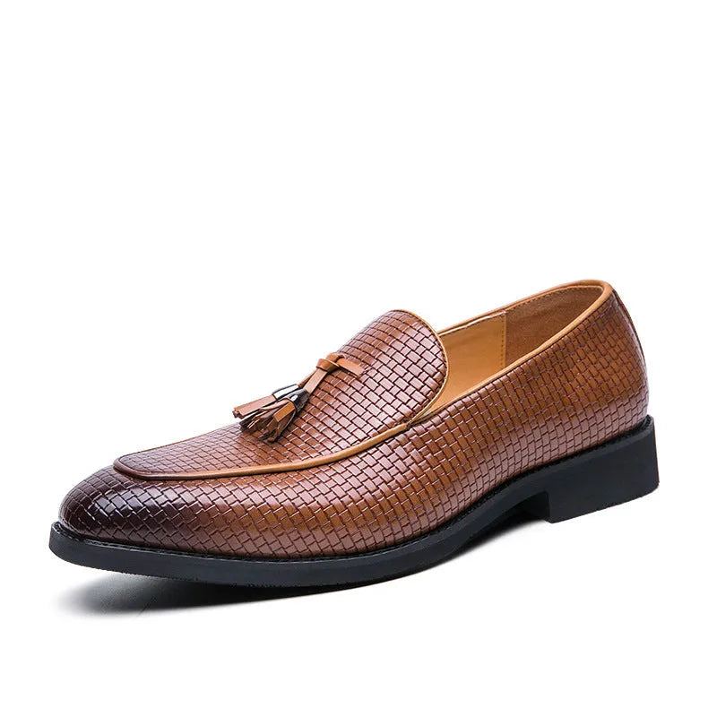 Men's black pointed toe slip-on shoes with a tassel detail on the front.