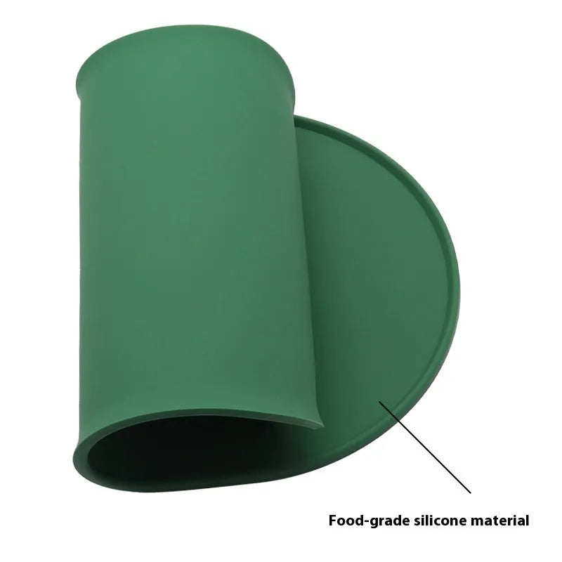 Silicone waterproof placemat for cat food and water bowls in beige colour on a wooden floor.