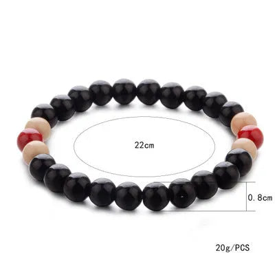 Natural stone beaded bracelet with lava stone charms on wrist, showing ethnic design and 18cm unisex fit.