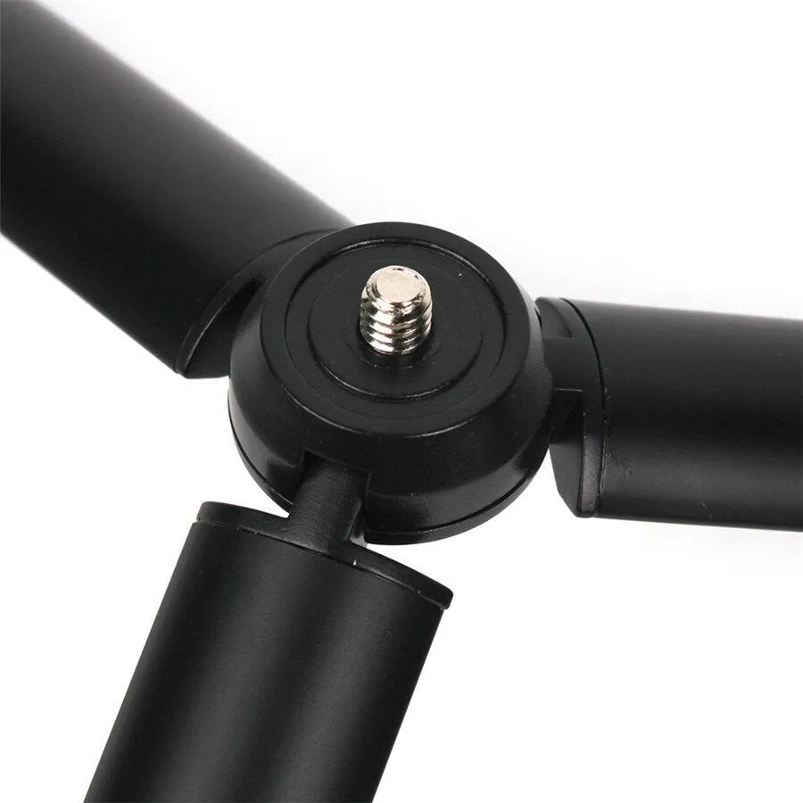 Black aluminium alloy mobile phone tripod and handheld stabiliser with telescopic legs extended.