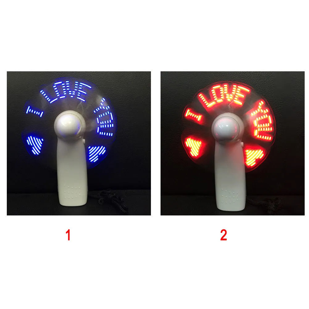 White handheld mini fan showing blue and red LED 'I love you' pattern flashing on front.