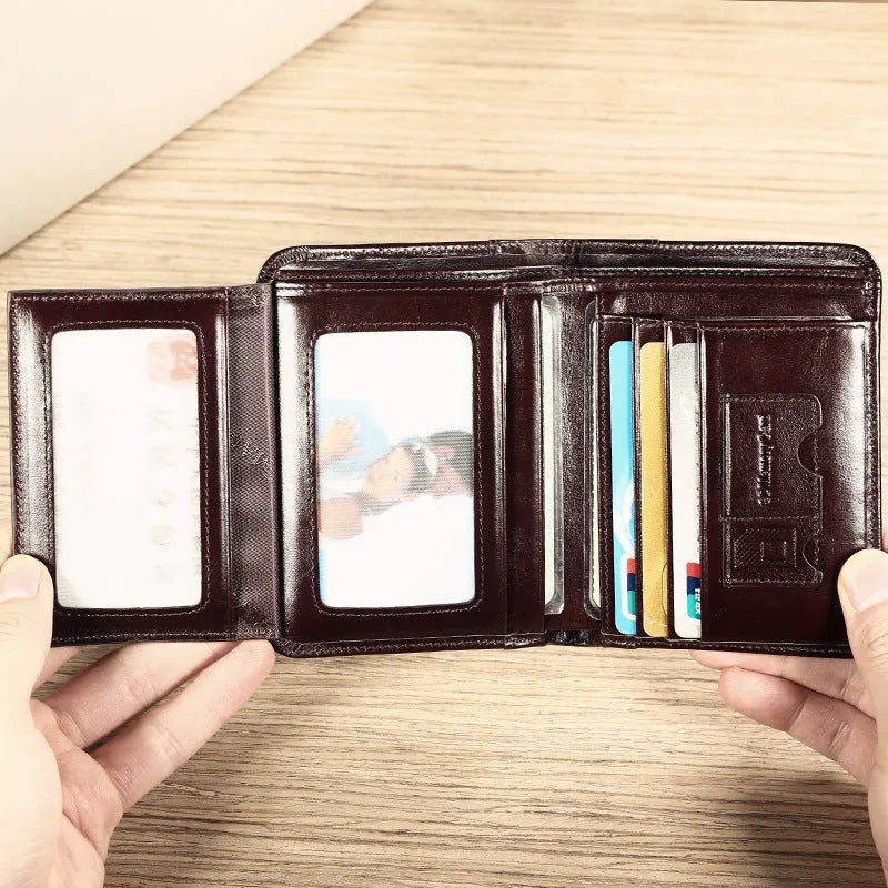 Men's black leather wallet open showing internal card slots, note compartment, and change section.