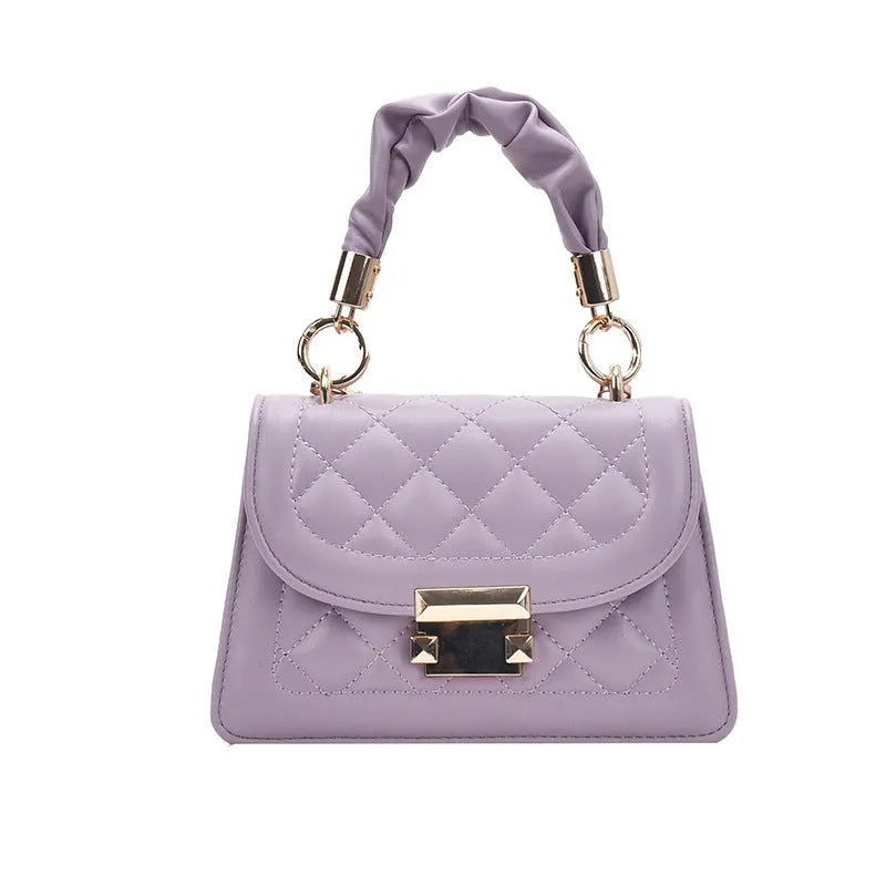 Purple rhombus-shaped women's shoulder bag with crossbody strap on mannequin