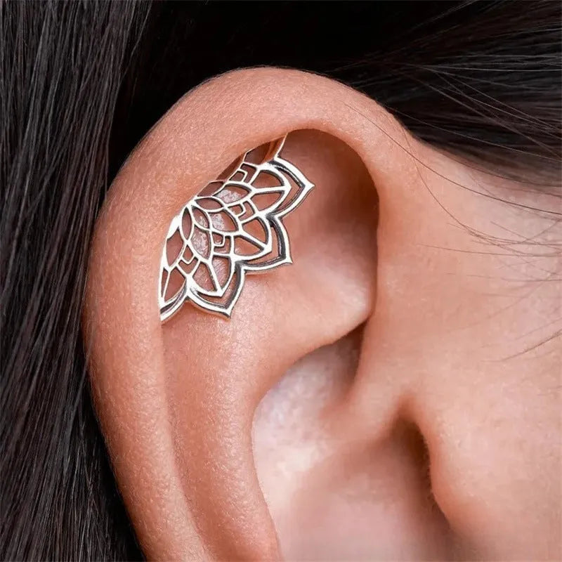 Geometric spider web stud earrings in gold and silver electroplated metal.