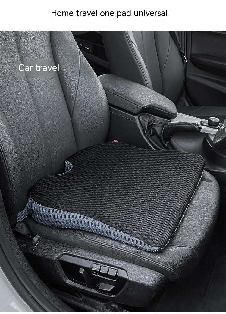 Memory foam car cushion with attachment straps in solid black colour on a car seat