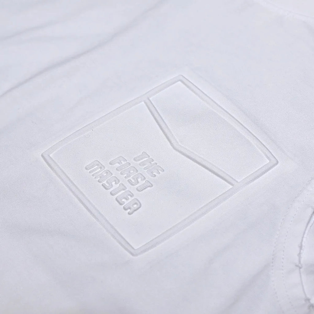 A man's solid colour loose-fit cotton sleeveless t-shirt with a straight hem.