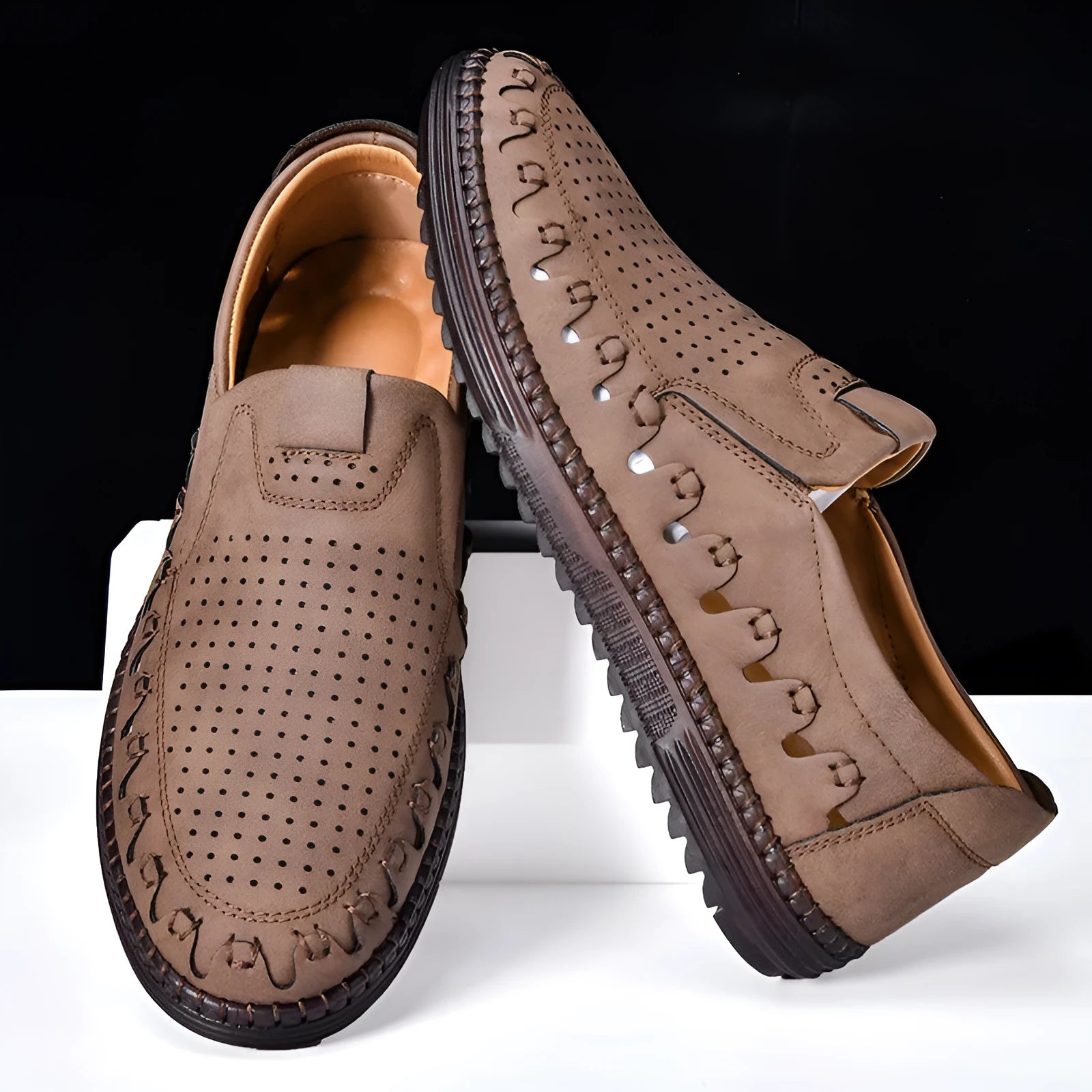 Men's brown casual slip-on shoes with round toe, hollowed detail, and sewn sole on a neutral background.