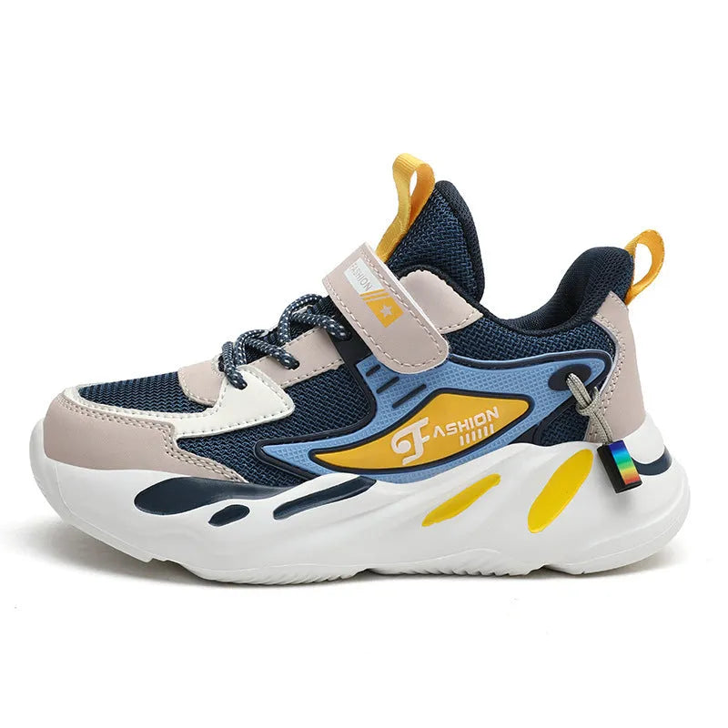 Boys' blue and black platform sports running shoes with Velcro strap on a hard ground surface.