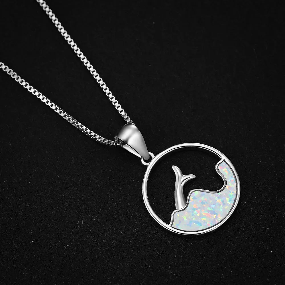 White gold electroplated geometric fishtail pendant necklace with a round blue opal stone.