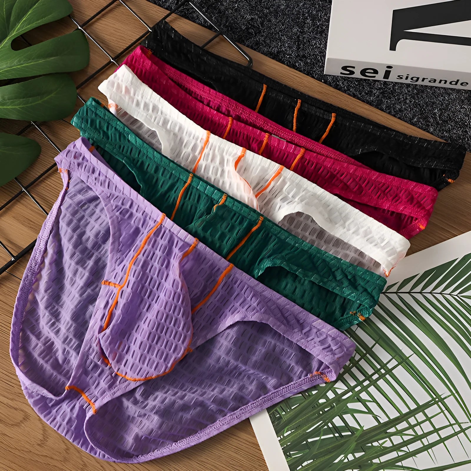 Men's solid colour low waist briefs in lace fabric for sports, shown in multiple colours.