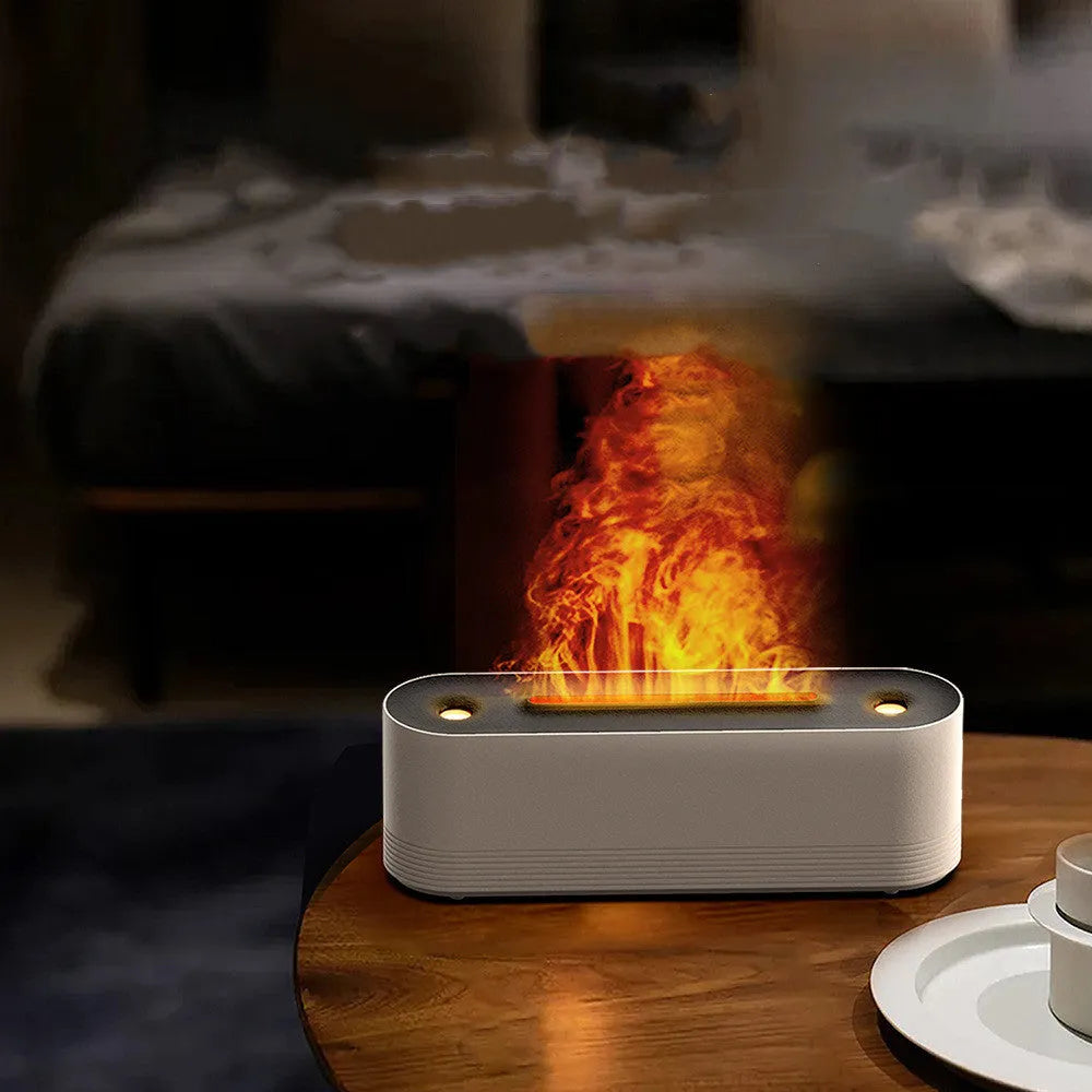 Black and white ultrasonic flame air humidifier and aroma diffuser with LED lights on a table.