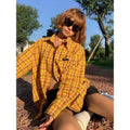 A loose-fitting dopamine yellow and black plaid cardigan-style shirt for men and women.