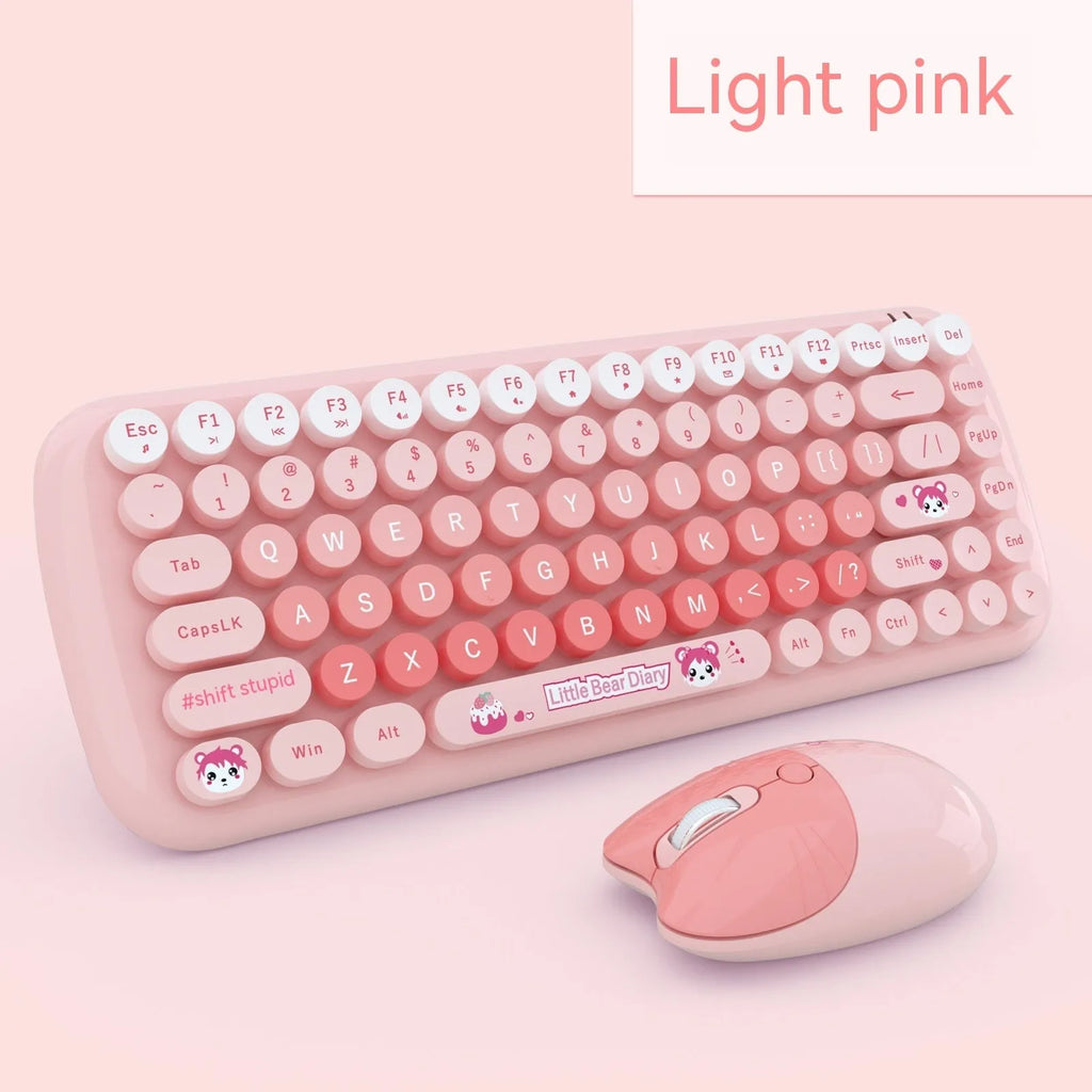 Pink mini cartoon wireless keyboard and mouse set with compact dimensions on desk