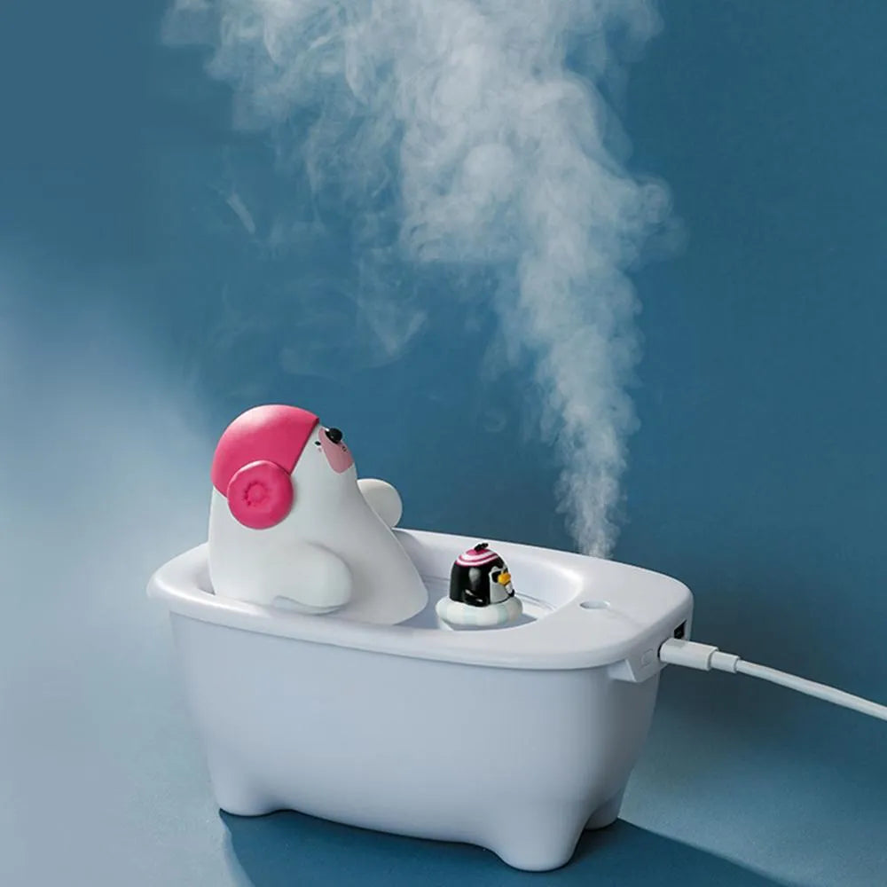 White USB-powered portable air humidifier and essential oil diffuser on a desk