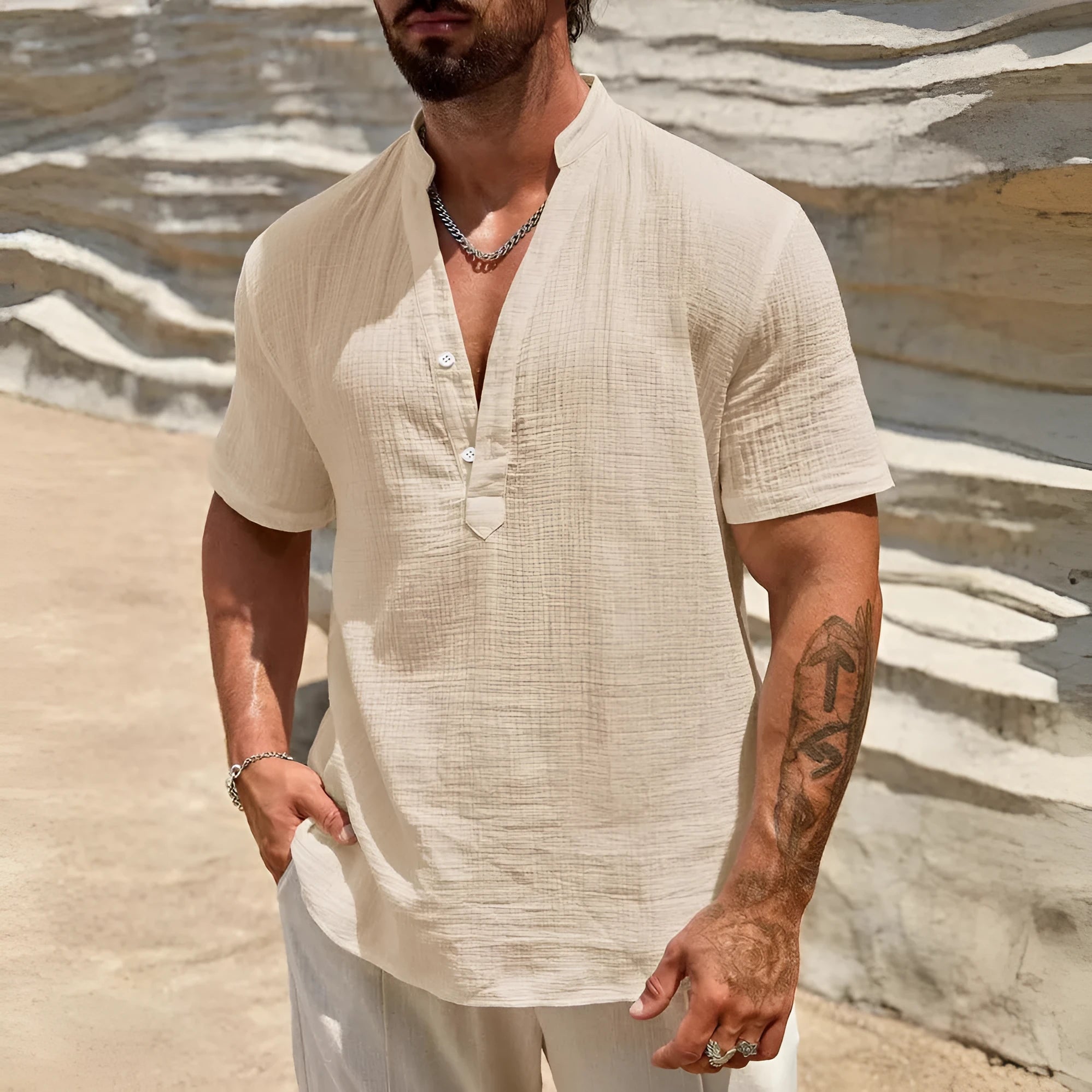 Man wearing a solid colour short sleeve casual shirt with a stand collar.