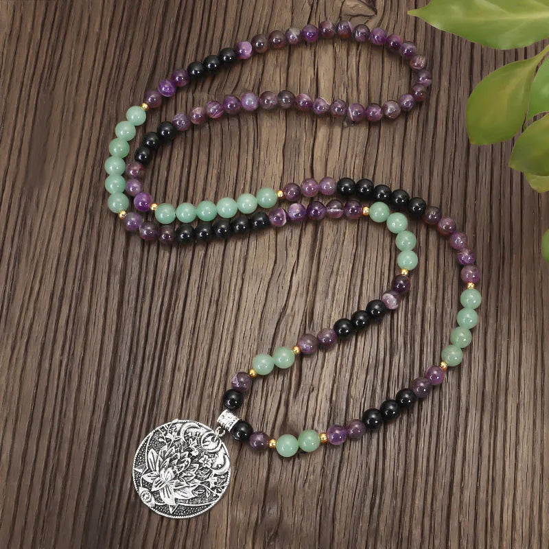 Handmade yoga necklace with lotus pendant and stone beads alongside matching bracelet