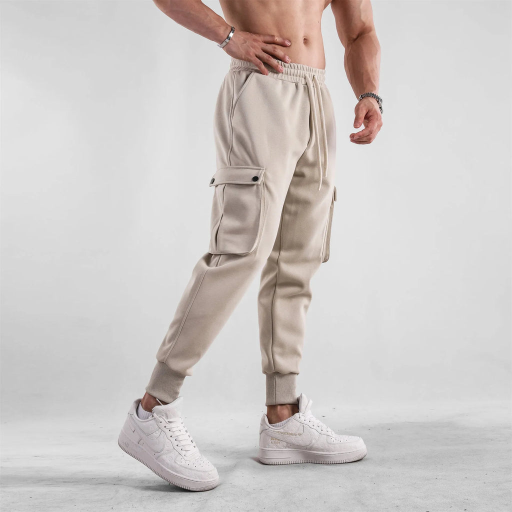 Men's loose cotton trousers with ankle ties in apricot colour showing multi-pocket design