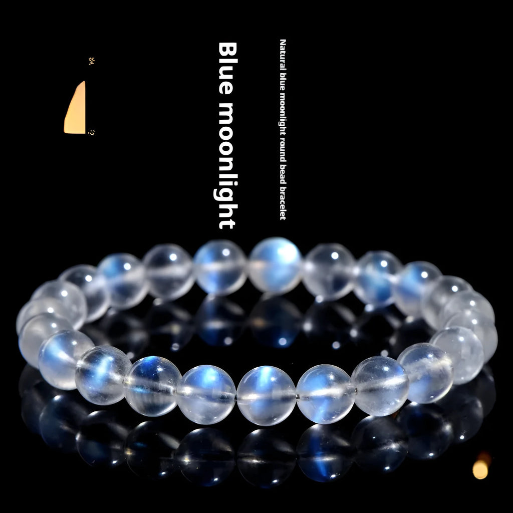 Natural blue moonlight cream body crystal bracelet on a wrist, showing polished beads.