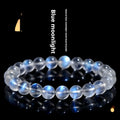 Natural blue moonlight cream body crystal bracelet on a wrist, showing polished beads.