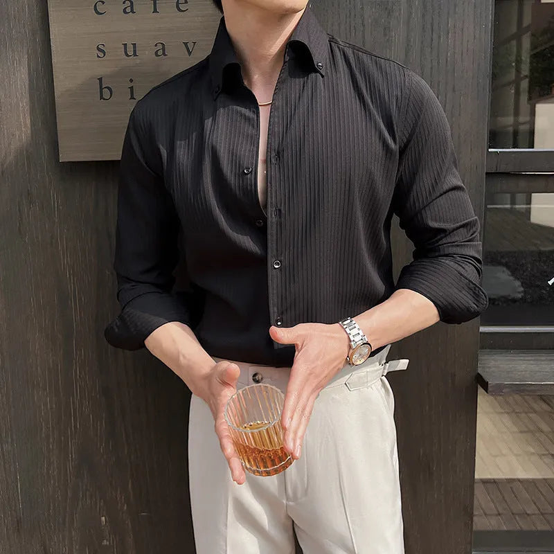 Man wearing a dark striped long sleeve V-neck cardigan shirt in a casual setting.