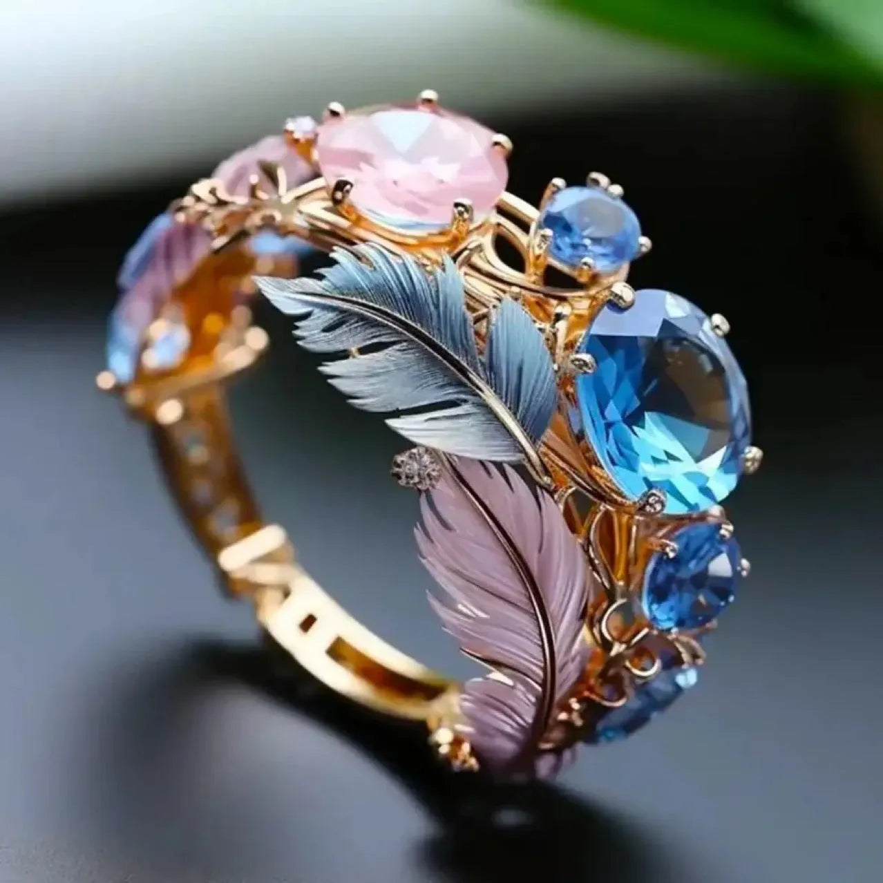 Gold-coloured brass ring with embossed feather design and geometric shape featuring zircon inlay details