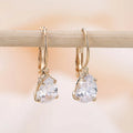 Drop-shaped women's metal earrings with gemstones in gold or platinum colour.
