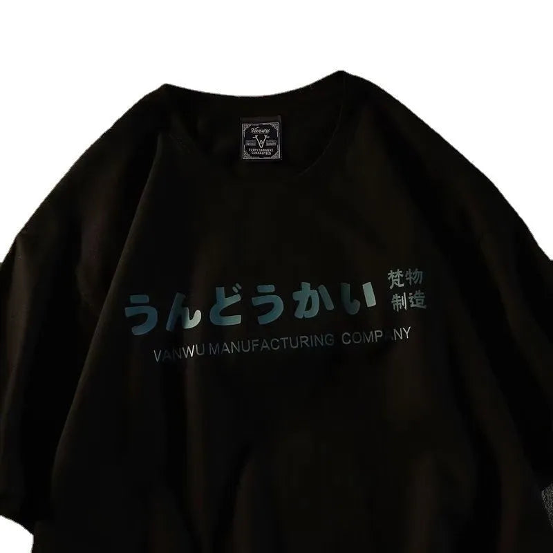 Man wearing a loose fit black cotton short sleeve T-shirt with a letter print.