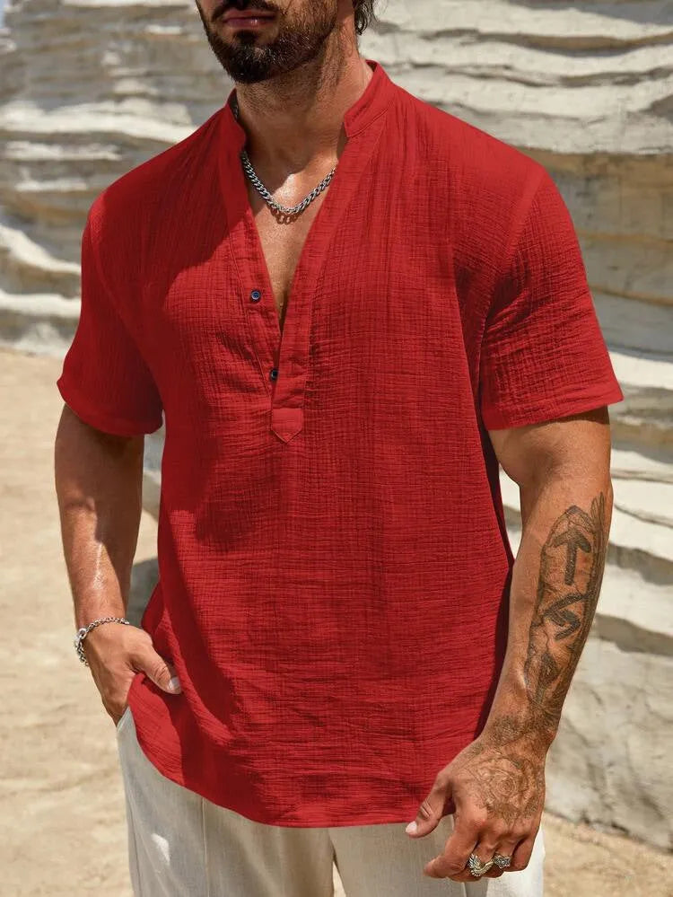 Man wearing a solid colour short sleeve casual shirt with a stand collar.