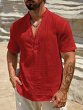 Man wearing a solid colour short sleeve casual shirt with a stand collar.