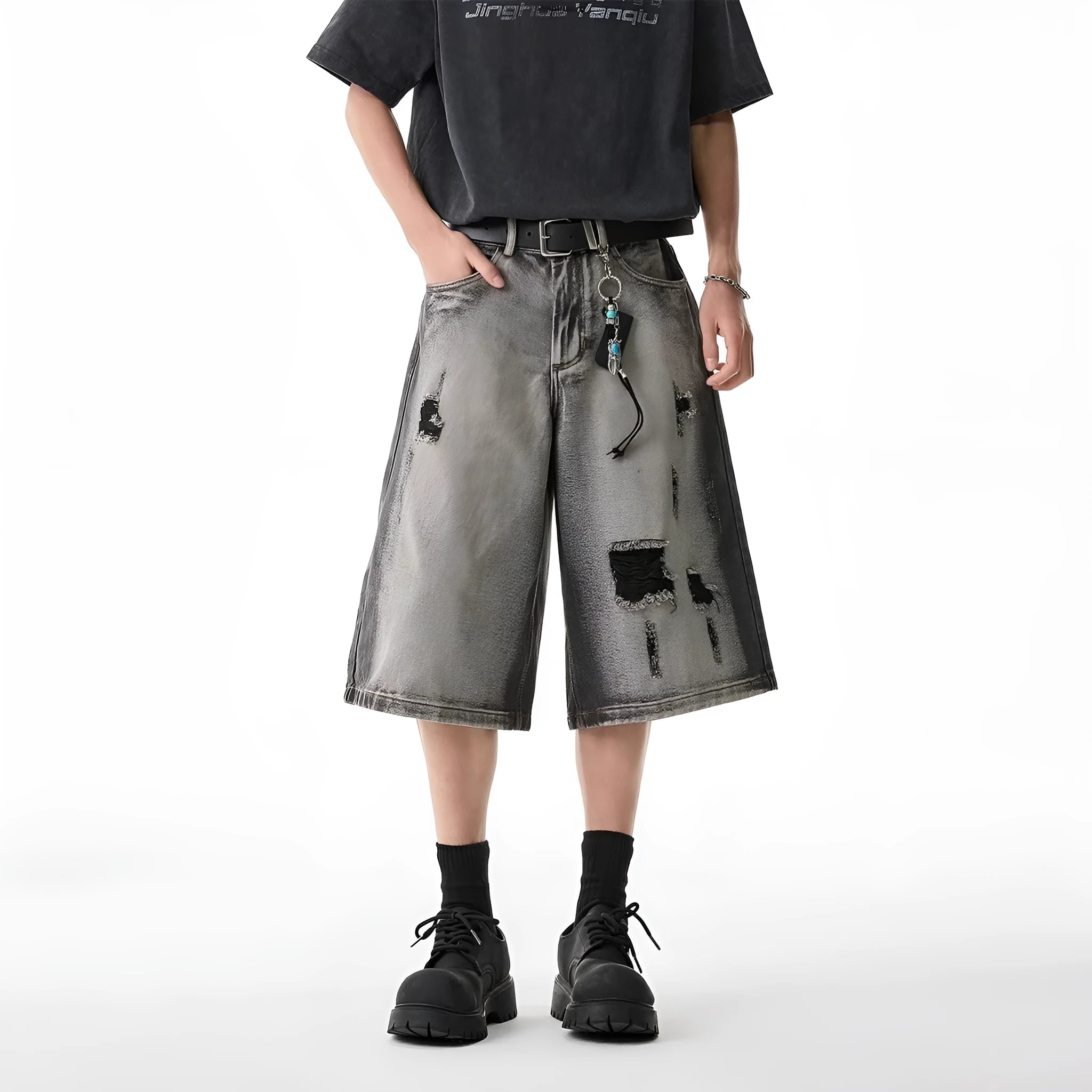 Grey high street washed cotton denim shorts with a loose, cropped fit on a hanger.