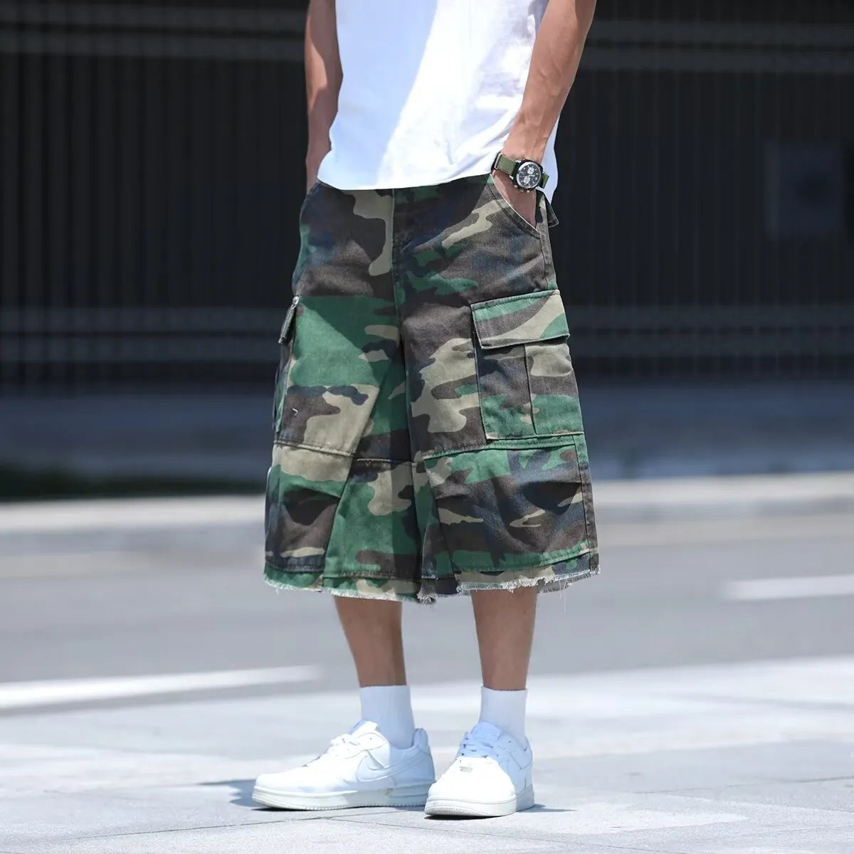 Man's loose-fit cotton shorts in a camouflage print with a cropped length and retro workwear style.