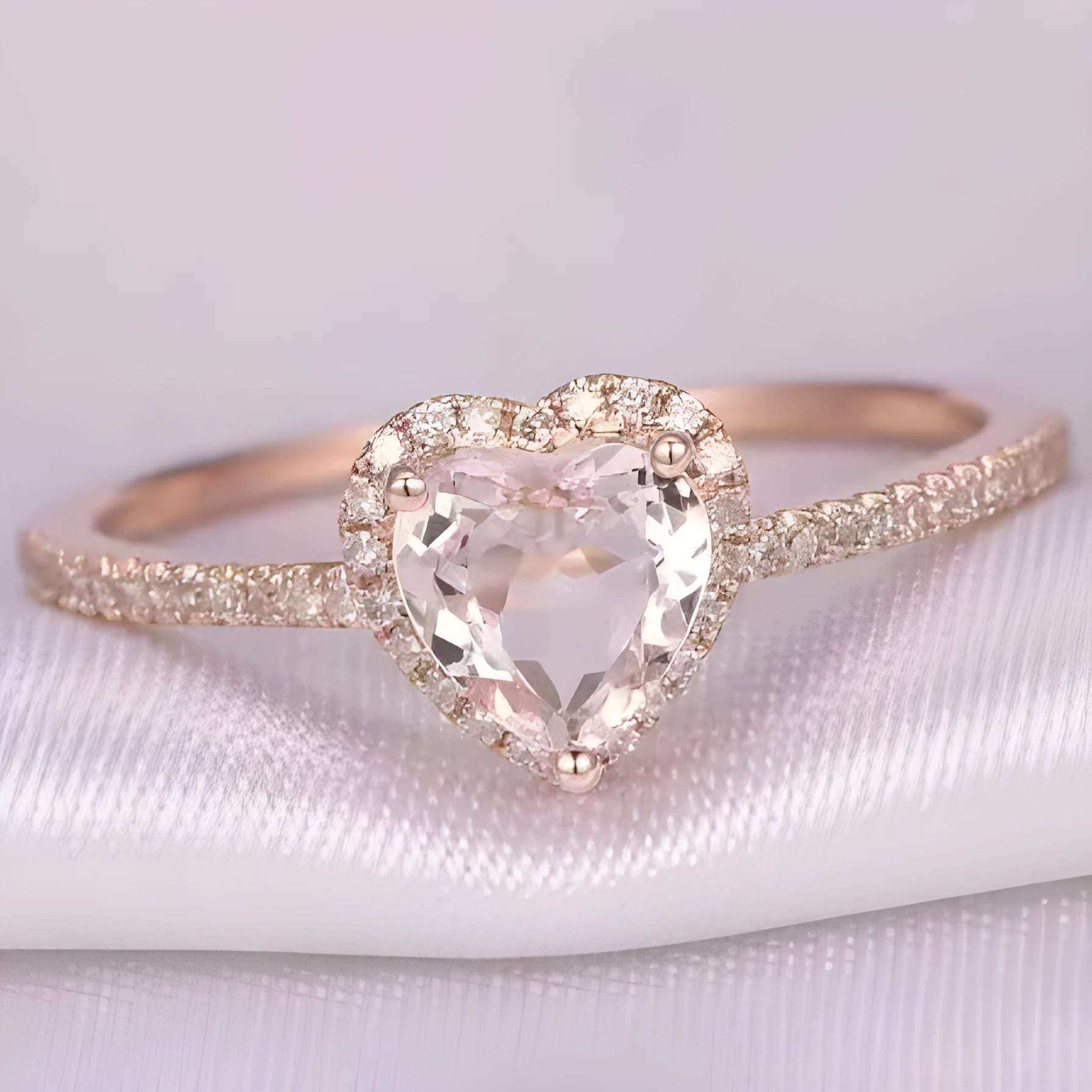 Women's heart-shaped crystal ring in rose gold or silver tone on a white background