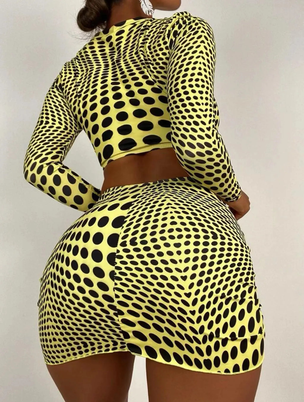 Women's green polka dot swimsuit three-piece set showing halterneck top and skirt