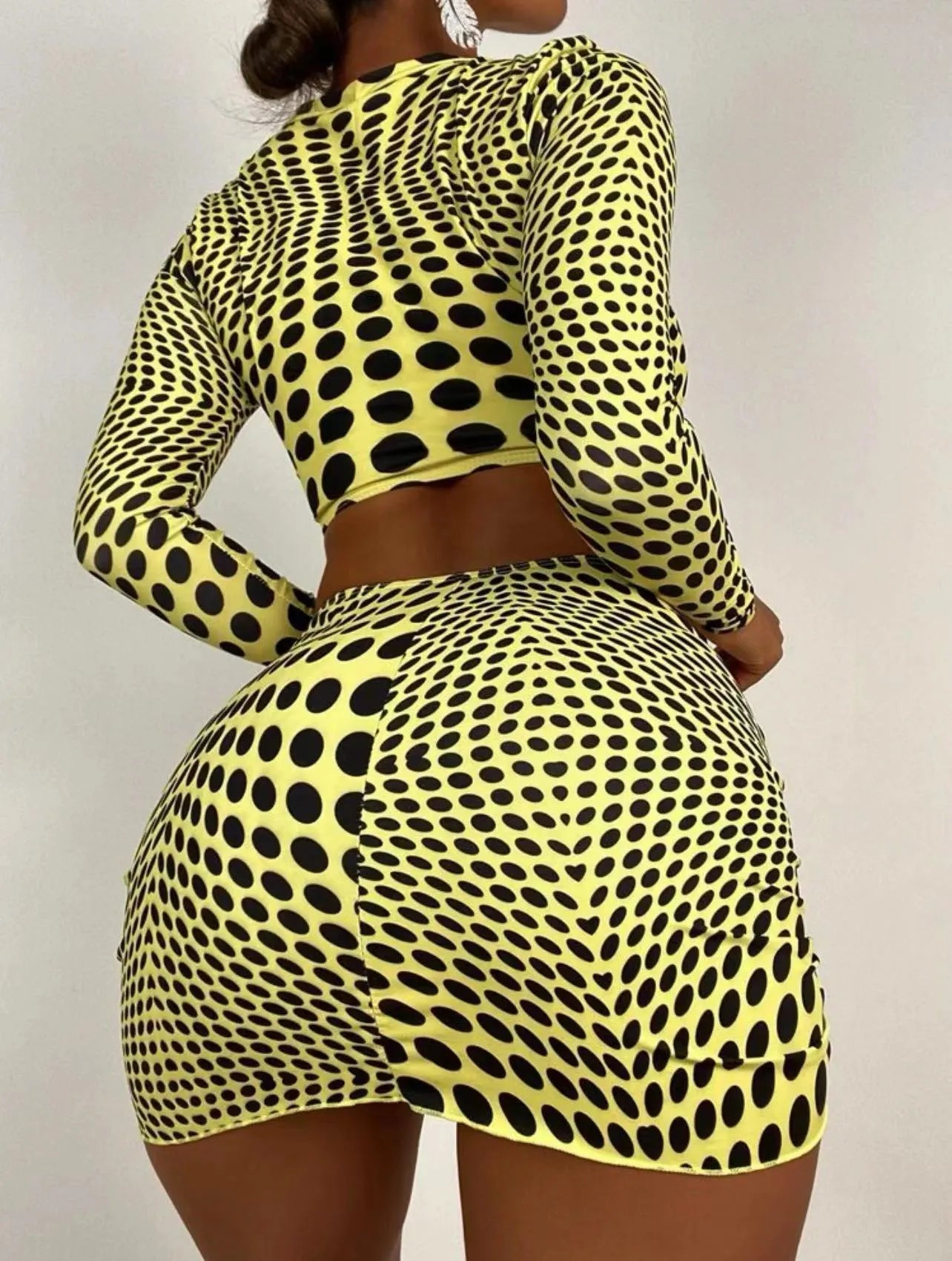 Women's green polka dot swimsuit three-piece set showing halterneck top and skirt