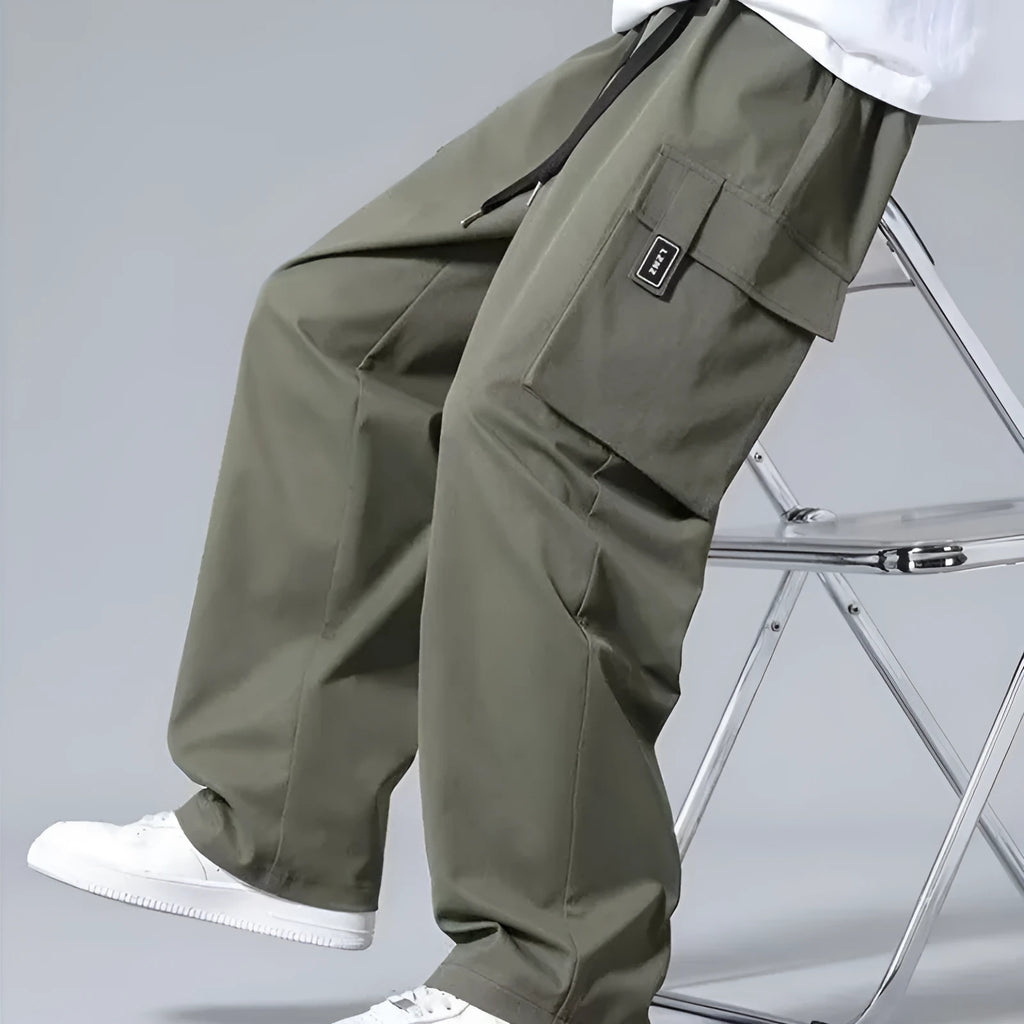 Boy's straight-leg cargo trousers in Army Green with drawstring waist and large side pockets.
