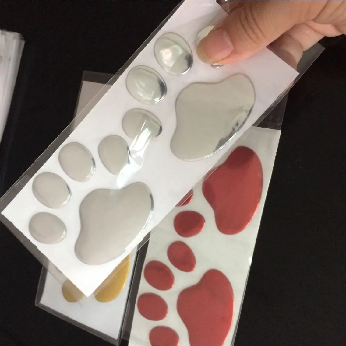 Hand-shaped brush design PVC car sticker with dog footprint pattern, shown in silver colour.