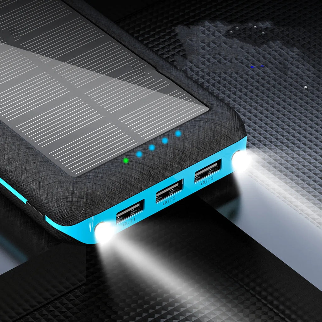 Black solar power bank with wireless Qi charging pad, three USB ports, and an LED flashlight