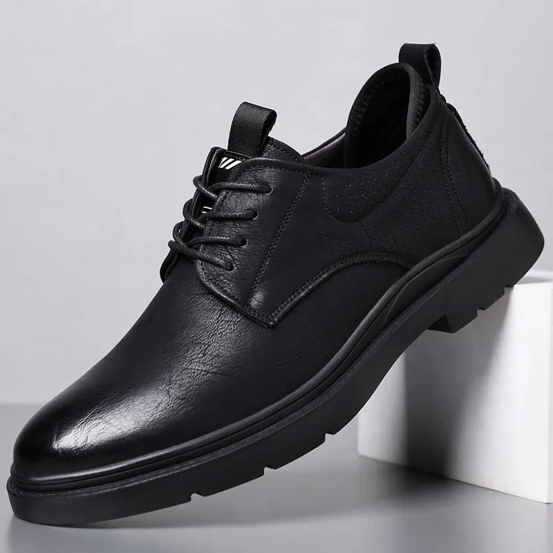 Men's black and brown leather sneaker with sewing line detail on a two-layer cowhide upper and rubber sole.
