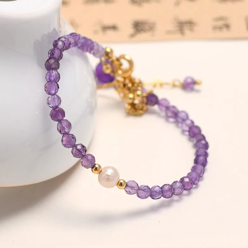 Purple amethyst crystal bracelet with diamond-shaped beads in a Chinese style design.