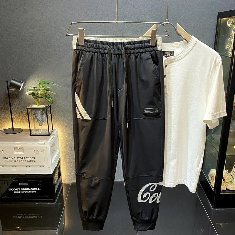 Black men's cropped casual trousers with an ankle band, made from ultra-thin cotton fabric.