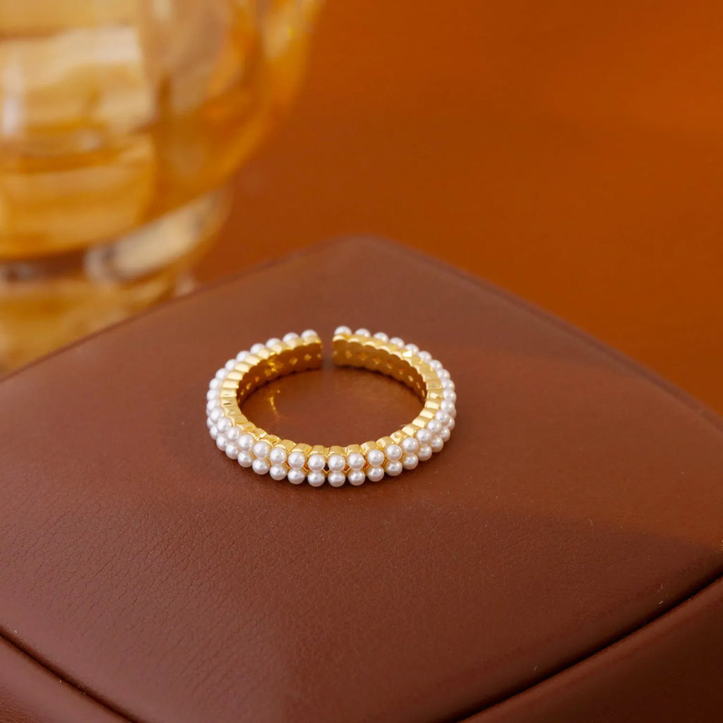 Gold geometric open mouth women's ring with round pearl-like elements on copper base