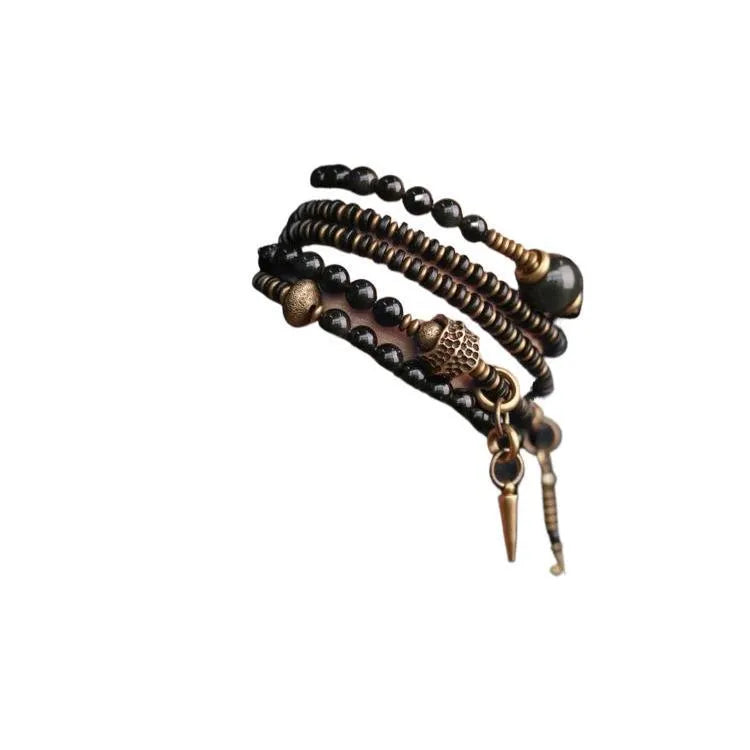 Close-up of a black multi-layered geometric bracelet made from beads, showing its textured construction.
