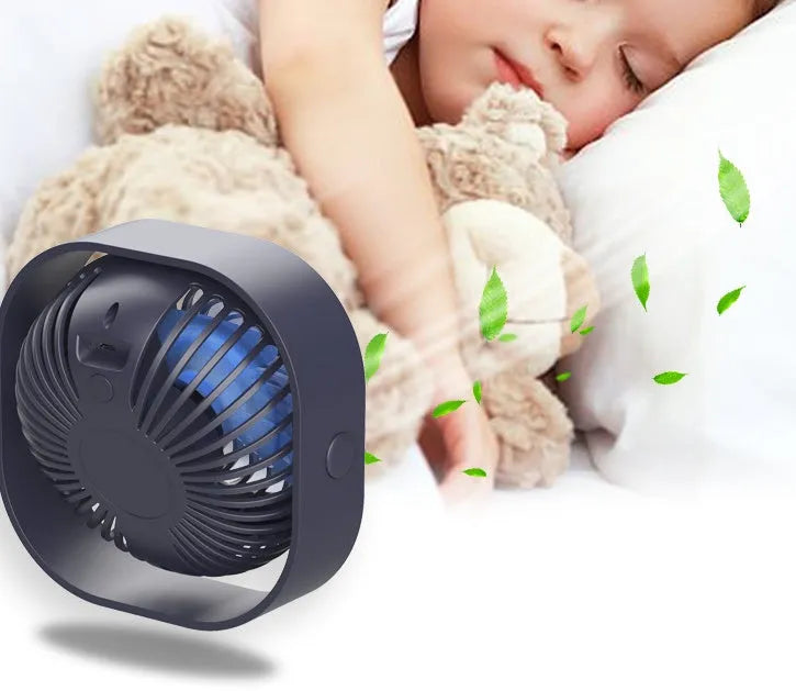 Compact USB desk fan with rotary switch shown in blue colour, demonstrating 360-degree rotation feature.