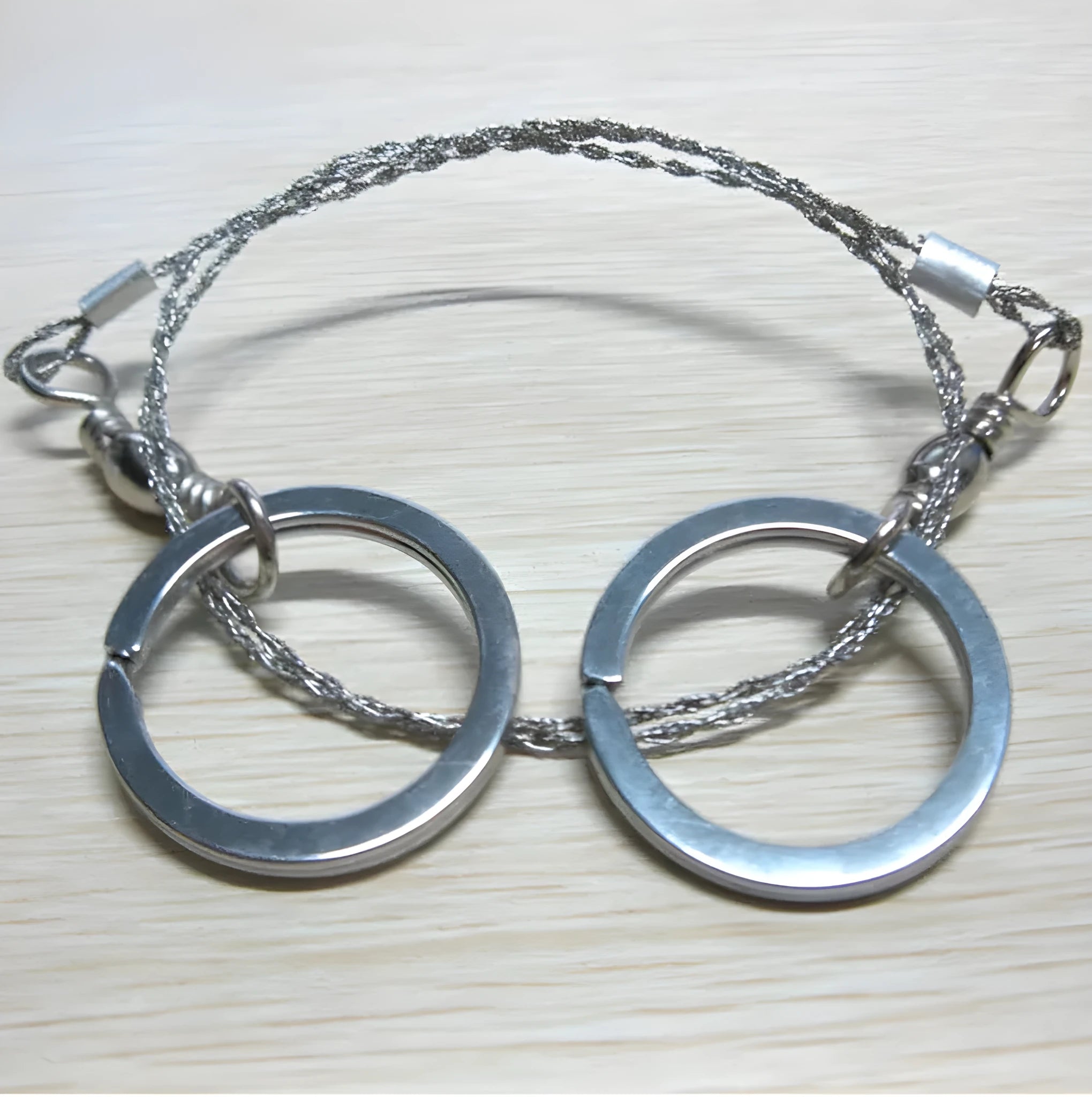 Outdoor survival wire saw with stainless steel blade, pull rings, and hoop showing 55cm cutting length