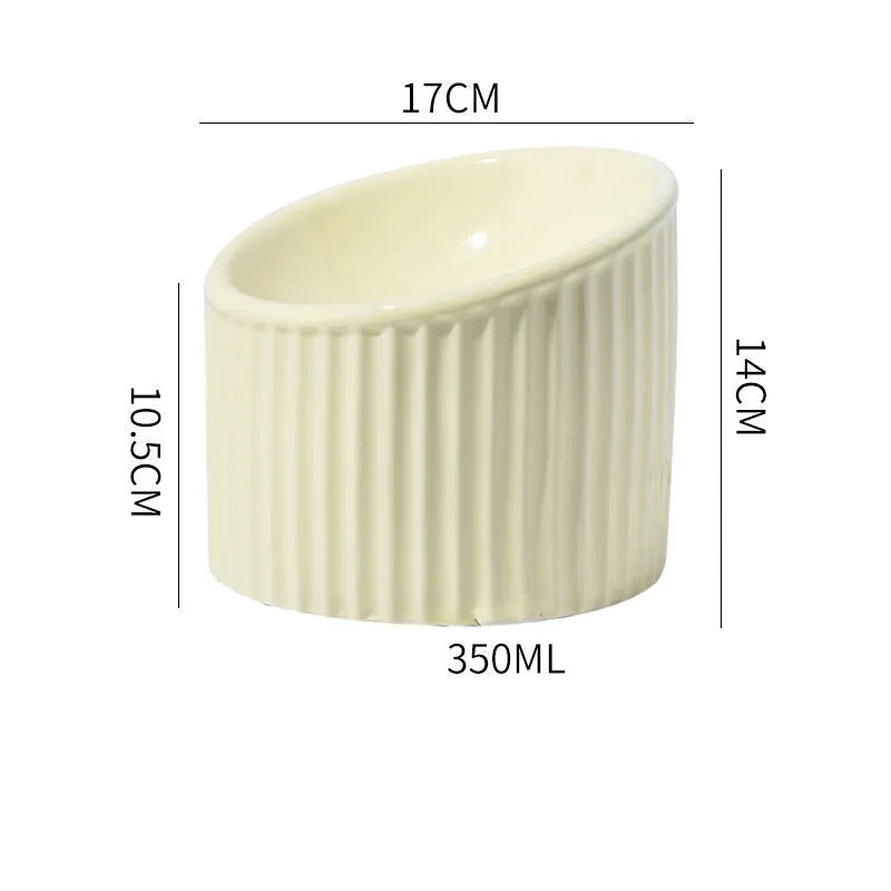 Ceramic elevated cat bowl in green or yellow with a tilted, round, whisker-friendly design.