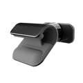 Black 360-degree rotating gravity car phone holder mounted on a car dashboard, holding a mobile phone.