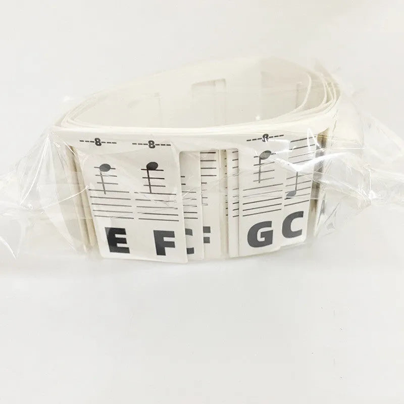 Set of white cardboard piano keyboard stickers showing colour note bars and black note labels for 88 keys.